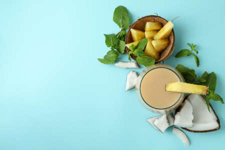 Pina colada cocktail and ingredients on blue background.の写真素材