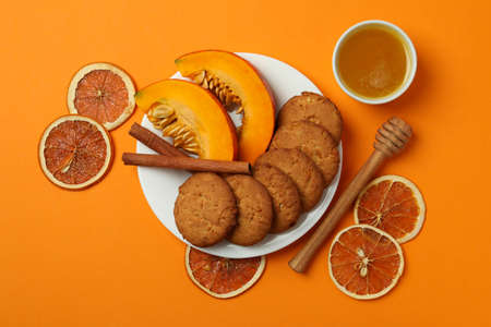 Concept of tasty food with pumpkin cookies on orange background.の写真素材