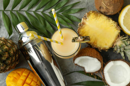 Pina colada cocktail and ingredients on gray textured background.の写真素材