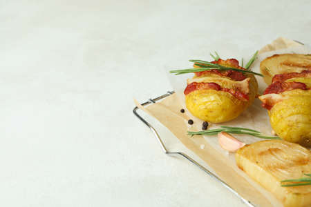 Concept of tasty food with baked potato on white textured background.の写真素材