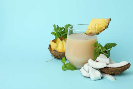 Pina colada cocktail and ingredients on blue background.の写真素材