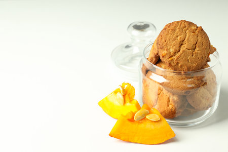 Jar with pumpkin cookies on white background.の写真素材
