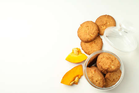 Jar with pumpkin cookies on white background.の写真素材
