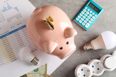 Energy saving concept on gray textured table.の写真素材