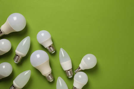 Energy saving bulbs on green background, space for text.の写真素材