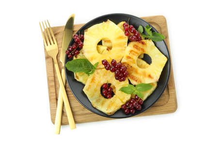 Board with grilled pineapple and cranberry isolated on white background.の写真素材