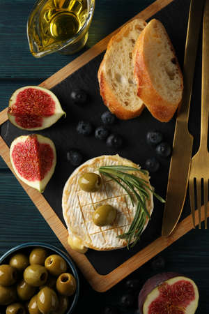 Concept of tasty food with grilled camembert on wooden background.の写真素材