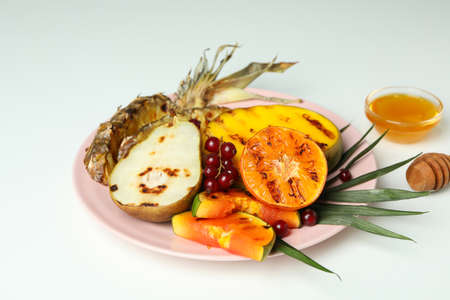 Concept of tasty food with grilled fruits on white background.の写真素材