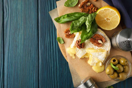 Concept of tasty food with grilled camembert on wooden background.の写真素材