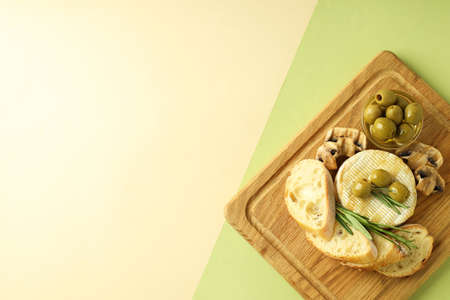 Concept of tasty food with grilled camembert on two tone background.の写真素材