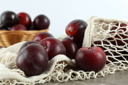 Concept of fruits with plums on gray textured table.の写真素材