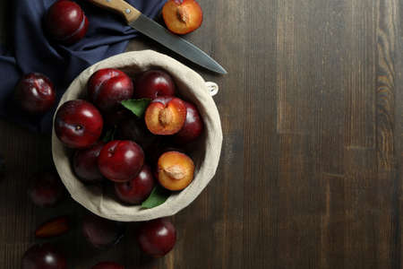 Concept of tasty food with plums on a wooden table.の写真素材
