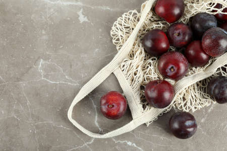 Concept of fruits with plums on gray textured table.の写真素材