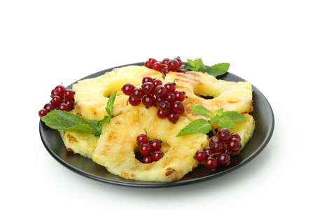 Plate with grilled pineapple and cranberry isolated on white background.の写真素材