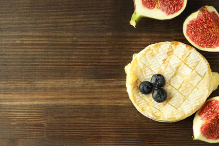 Concept of tasty food with grilled camembert on wooden background.の写真素材