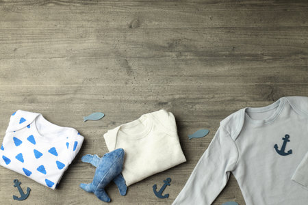 Concept of cute baby clothes on gray textured background.の写真素材