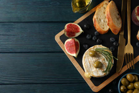 Concept of tasty food with grilled camembert on wooden background.の写真素材