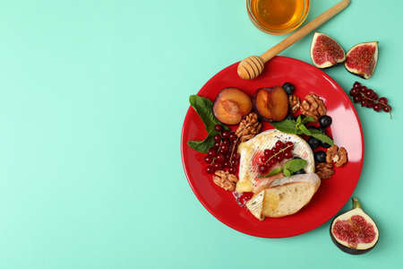 Concept of tasty food with grilled camembert on mint background.の写真素材