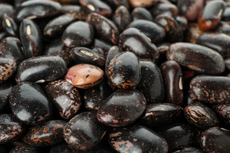 Black beans, all over background, close up.