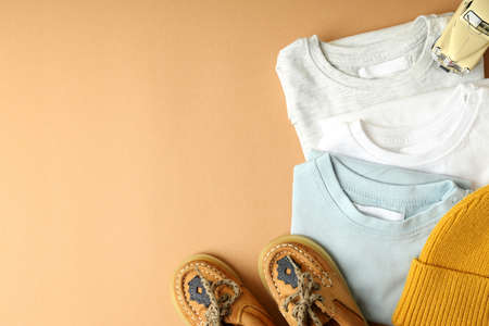Concept of baby clothes on beige background.の写真素材