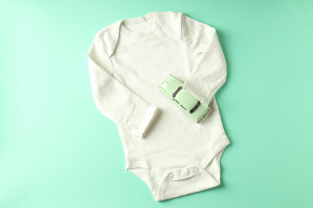 Romper and toy car on mint background.の写真素材