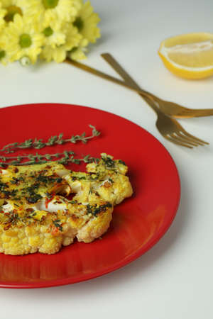 Concept of tasty food with baked cauliflower on white background ..の写真素材