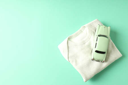 Romper and toy car on mint background.の写真素材