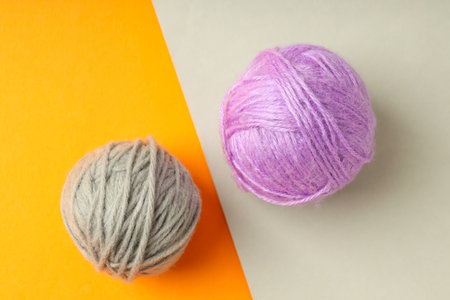 Multi colored balls of yarn on two tone background.の写真素材