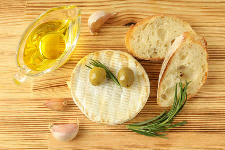 Concept of tasty food with grilled camembert on wooden background.の写真素材