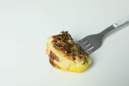 Fork with baked cauliflower on white background.の写真素材