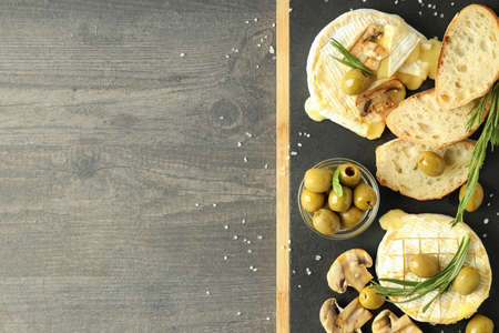Concept of tasty food with grilled camembert on dark wooden background.の写真素材