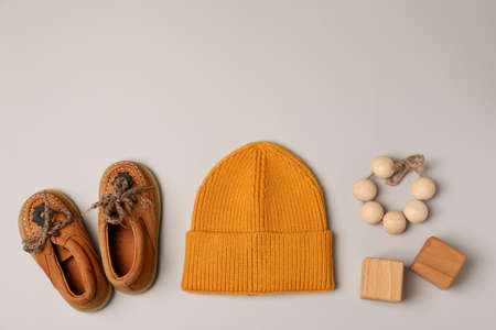 Baby shoes, hat and toys on light gray background.の写真素材