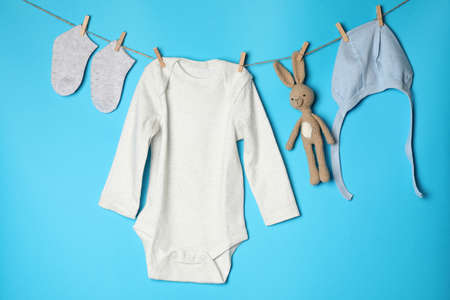 Concept of cute baby clothes on blue background.の写真素材