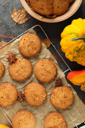 Concept of tasty food with pumpkin cookies on dark textured background.の写真素材