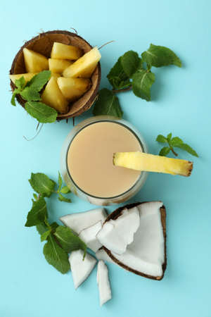 Pina colada cocktail and ingredients on blue background.の写真素材