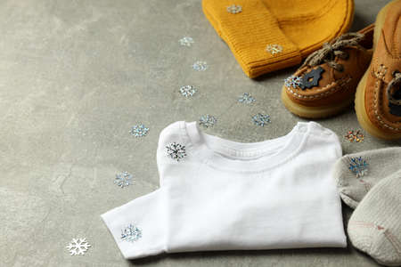 Concept of baby clothes on gray textured background.の写真素材