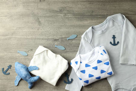 Concept of cute baby clothes on gray textured background.の写真素材