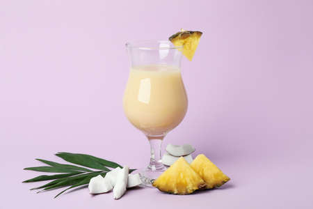 Pina colada cocktail and ingredients on violet background.の写真素材