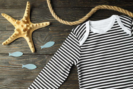 Marine concept of baby clothes on wooden background.の写真素材