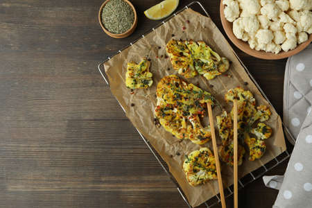 Concept of tasty food with baked cauliflower on wooden background.の写真素材