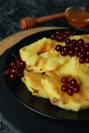 Concept of tasty food with grilled pineapple on black smokey background.の写真素材