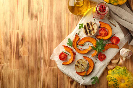 Concept of cooking with baked pumpkin on wooden background.の写真素材