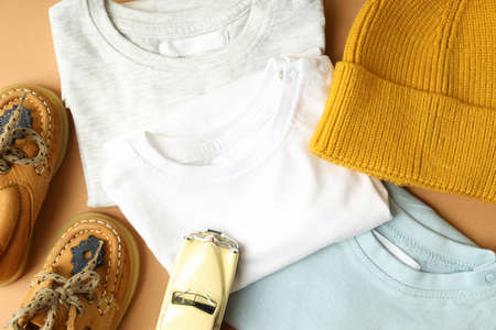 Concept of baby clothes on beige background.の写真素材