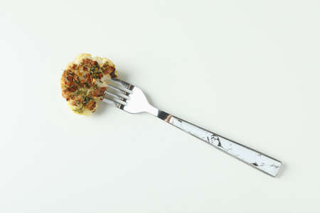 Fork with baked cauliflower on white background.の写真素材