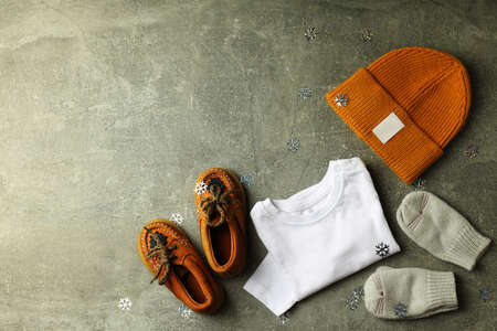 Concept of baby clothes on gray textured background.の写真素材