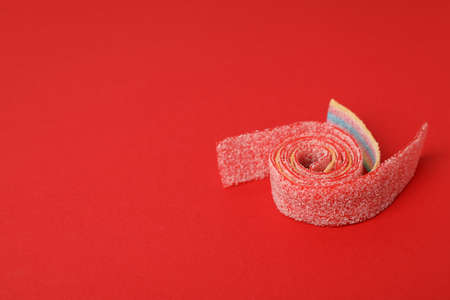 Gummy candy on red background, space for text.の写真素材