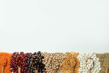 Spoons with different types of beans on white backgroundの写真素材