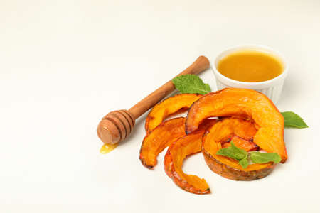 Baked pumpkin, mint, honey and dipper on white background.の写真素材