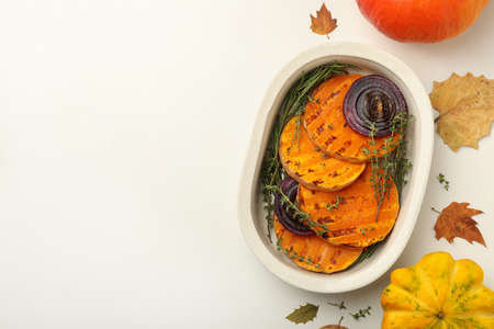 Autumn concept with baked pumpkin on white background.の写真素材