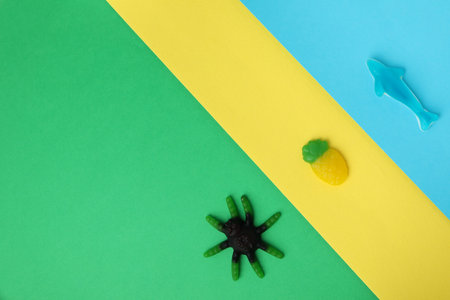 Tasty gummy candies on three tone background.の写真素材